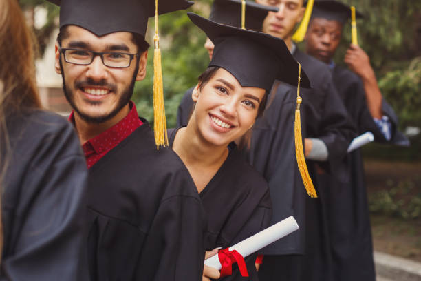 istock Group of multiethnic students on graduation day 969628346