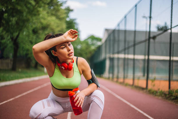 istock Tired woman runner taking a rest after running hard 969629106