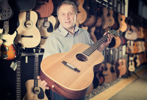 istock male is standing with modern guitar 969637358