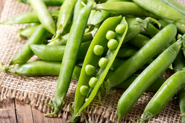 istock green peas pod on wooden table 969658172