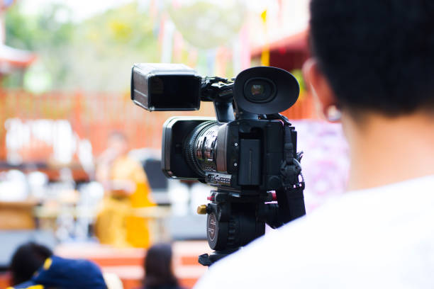 professional cameraman - covering on event with a video stock photo