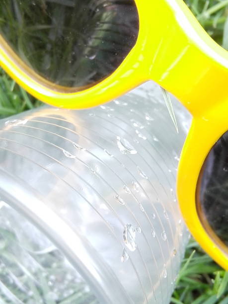 istock Disposable bottle of water with plastic glass with ice 969670752