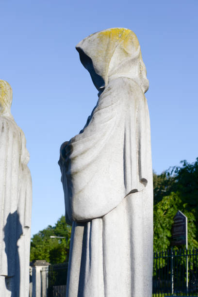 istock faceless monk statue outside church 969672382