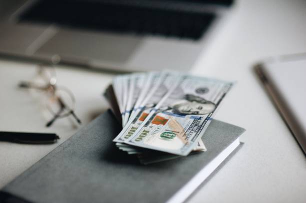 istock Close-Up Of Paper Currency On Diary Over Table 969679714