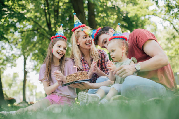 istock Toddle having outdoors birthday party with a cake 969680166