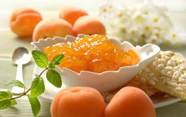 istock apricot jam in the white bowl with fruit around 969680272