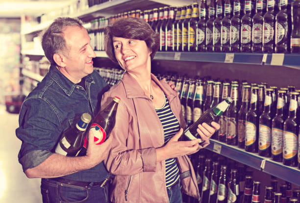 istock Husband and wife selecting a beer at  store 969680504