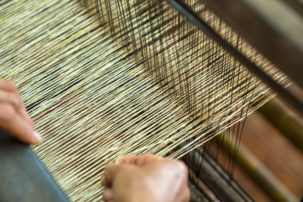 istock Weaving silk in traditional way in Vietnam. Vietnamese silk processing. 969680840