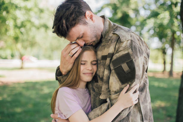 istock Sad soldier hugging with his daughter 969681036
