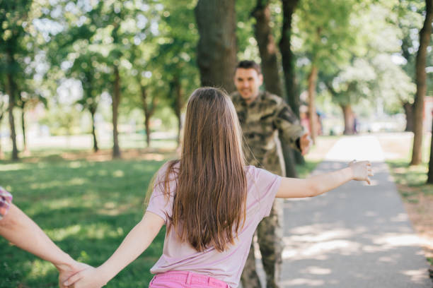 istock Girl running towards a soldier 969683972