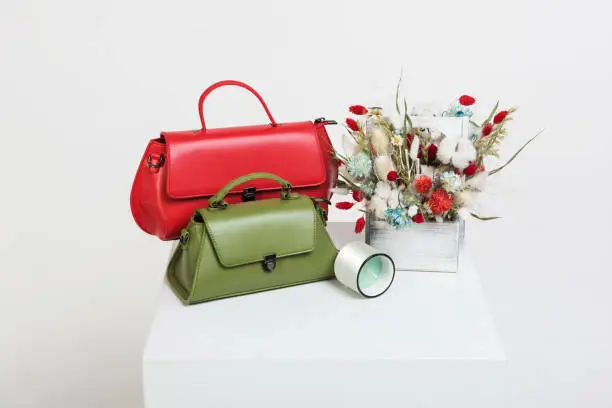 Photo of Female handbag and bouquet of dried flowers