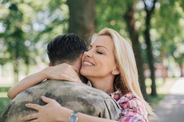istock Excited wife hugging a man in military uniform 969685516