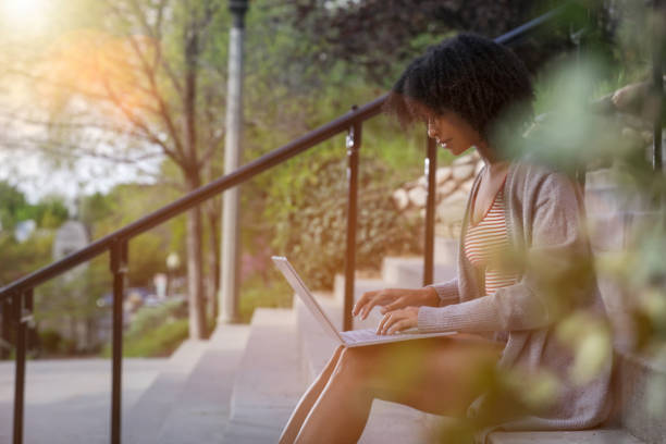 istock Woman working on laptop on stairs 969687858