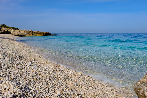 The beautiful beach of Lalaria, Skiathos island, Sporades, Greece, with light gray pebble stones and turquoise, shining sea