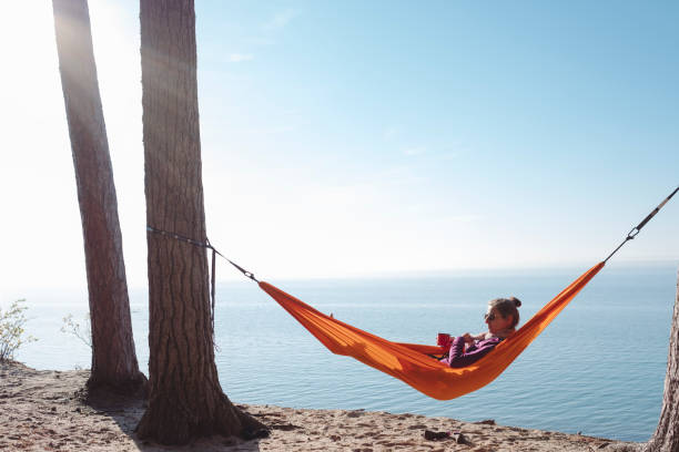 istock Woman in hammock looking at lake 969692408