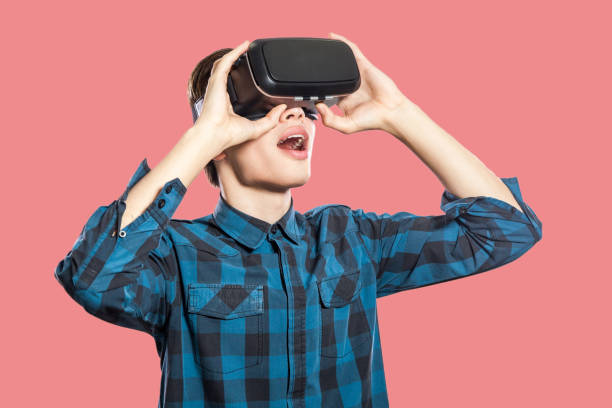 istock Young man with vr headset on pink background. 969704028