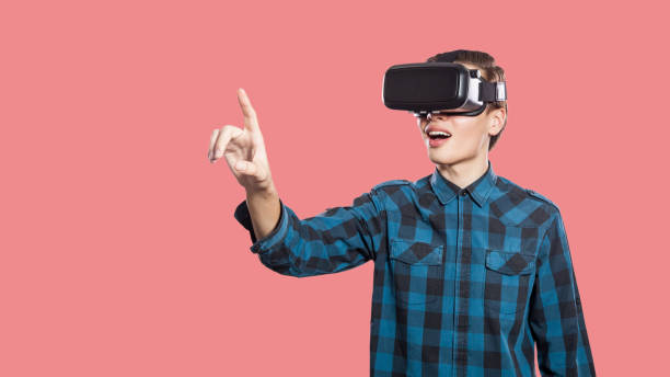 istock Young man with vr headset on pink background. 969704044