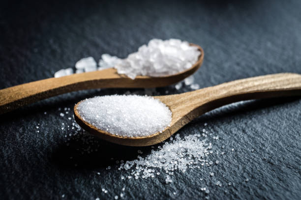 istock Different types of salt. Top view on two wooden spoons 969704380