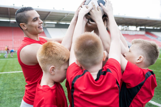 istock Football Team Holding Ball 969704790