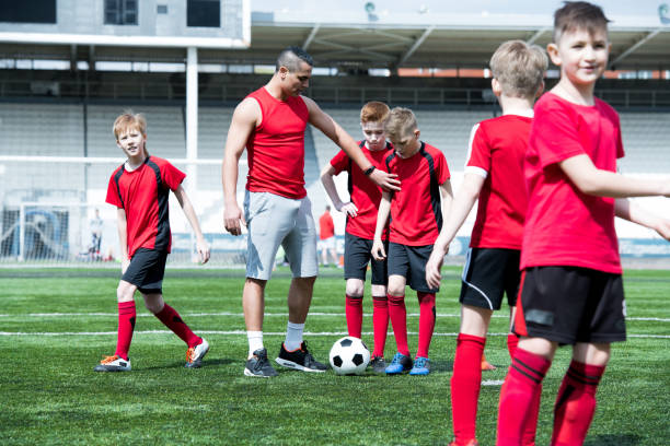 istock Coach Teaching Football Team 969704822