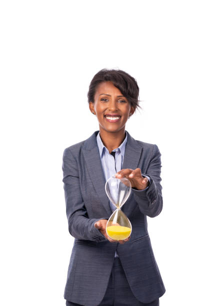 businesswoman with an hourglass. - businesswoman black african descent studio shot imagens e fotografias de stock