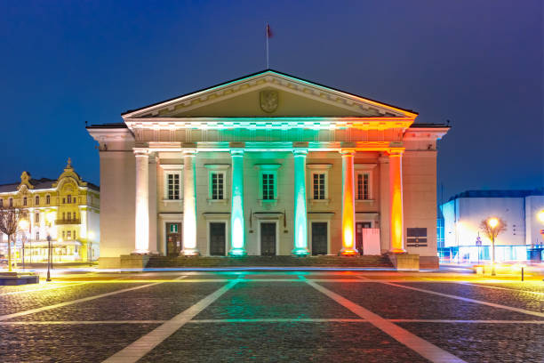 Town Hall Square in Old Town illuminated by the colors of the national Lithuanian flag at night of Vilnius, Lithuania, Baltic states.
