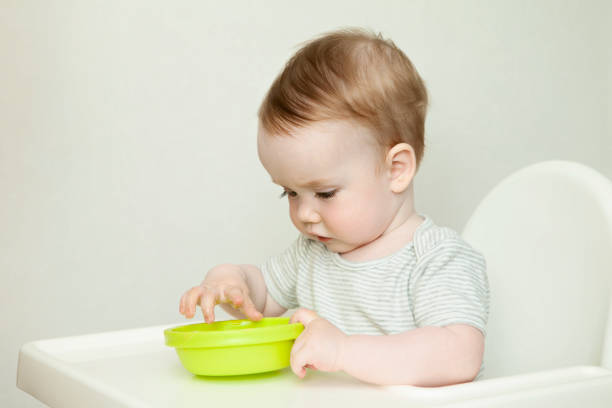 istock baby boy eating from a plate 969717248