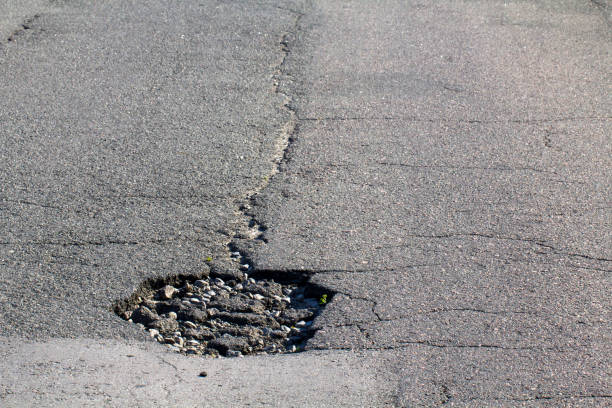 istock there are many potholes on the roadway close up 969719758