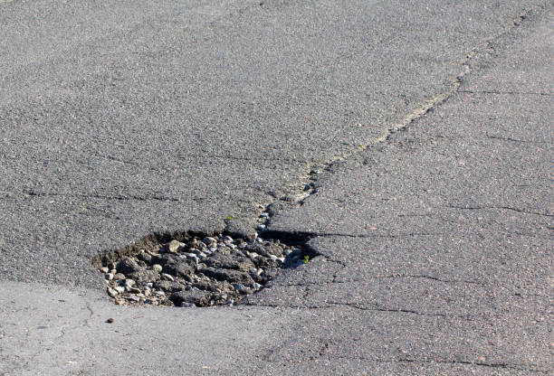 istock there are many potholes on the roadway close up 969719774