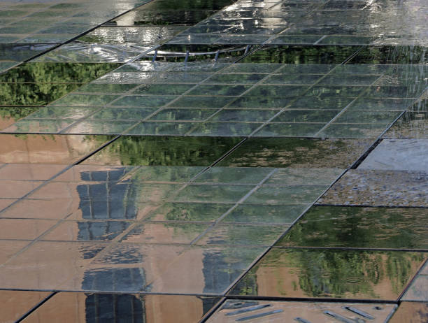 istock Wet public outdoor tiled space reflecting greenery 969720088