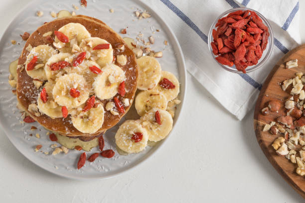 istock Pancakes with banana, walnuts, goji and honey 969720408