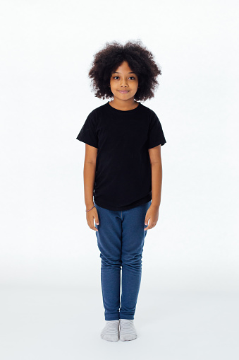 Pre-teen African American kid in casual style standing still isolated in white background