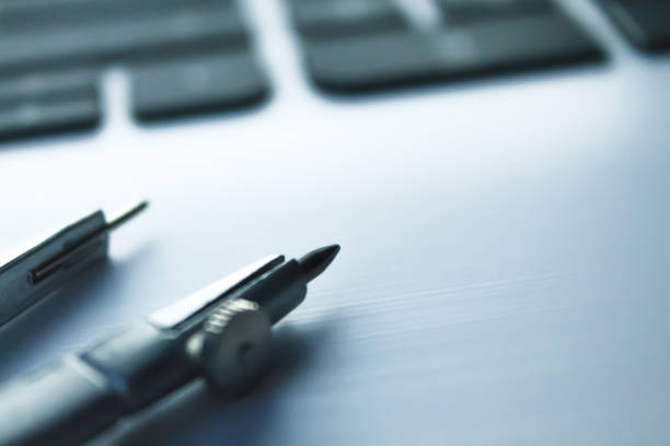 istock metallic compass on a white laptop with a black keyboard 969755878