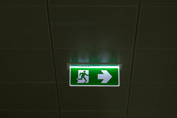 istock Green emergency exit sign showing the way to escape. 969773394