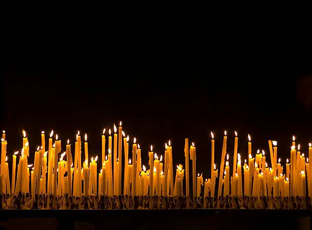 Background of burning candles in  a church.