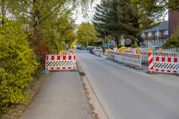 istock Construction site on a pedestrian path, barricades illuminated with orange warning lamps blocking the sidewalk 969806552