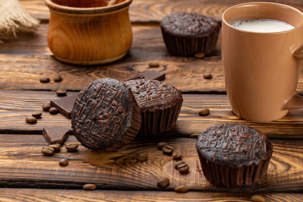 istock Chocolate muffins on a broun rustic wooden table - selective focus 969806870