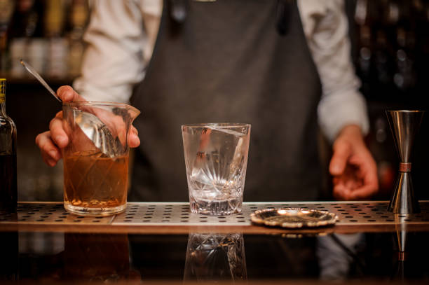 istock Bartender holding a mixing glass with an alcoholic drink 969827230