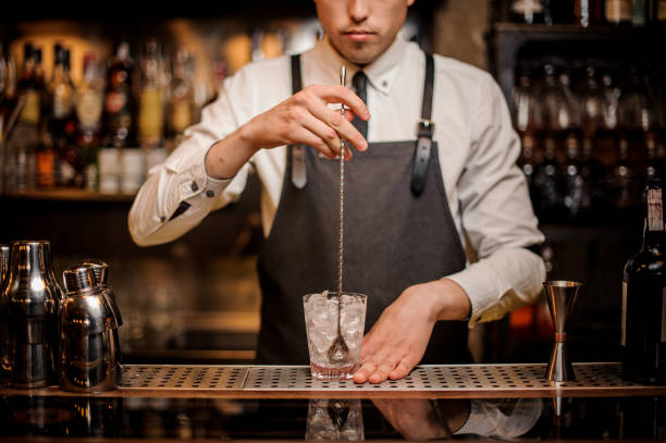 istock Bartender stirring ice in the ornate glass 969827350
