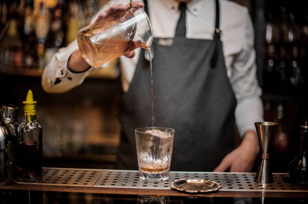 istock Bartender pouring a delicious alcoholic drink from a mixing glass 969831610