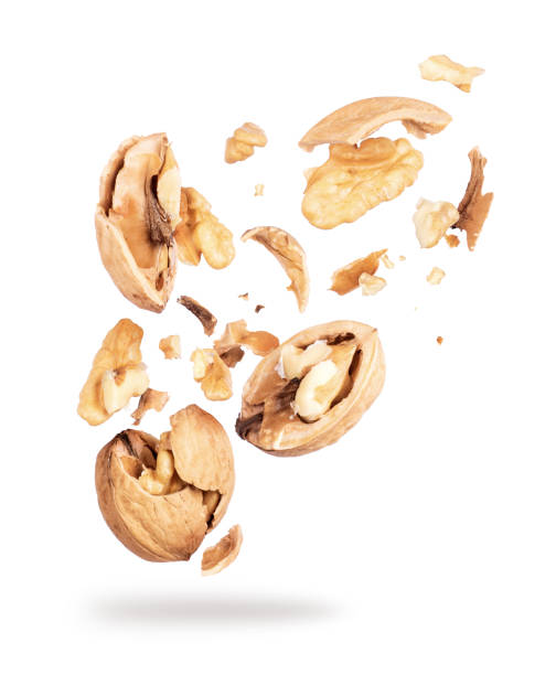 istock Walnuts crushed into pieces close-up isolated on white background 969841148