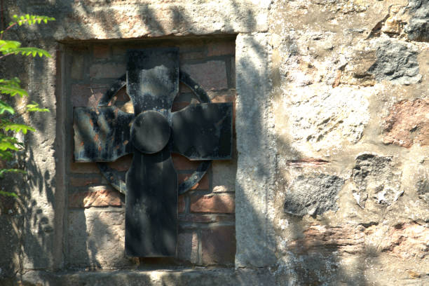 Black Celtic , Sorn kirkyard Image of a black cross found on the wall of the kirkyard at Sorn, Ayrshire, Scotland kirkyard stock pictures, royalty-free photos & images