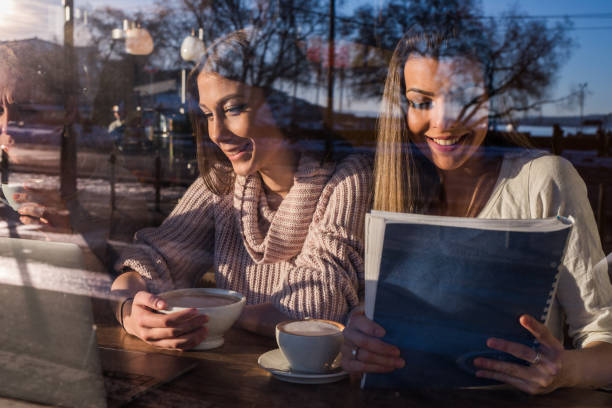 istock To young females studying in cafeteria. 969845122