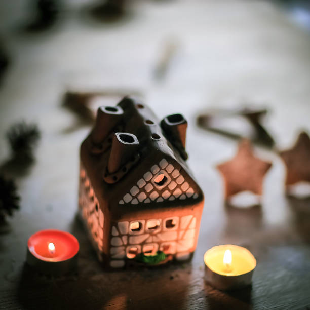 istock gingerbread house candle on blurred background of the table 969847924