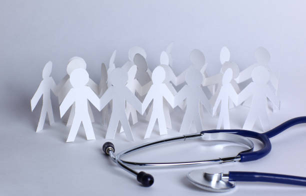 istock stethoscope and paper men on the table 969848658