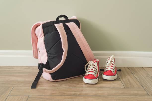 istock School backpack and sneakers on the floor in home interior 969859326
