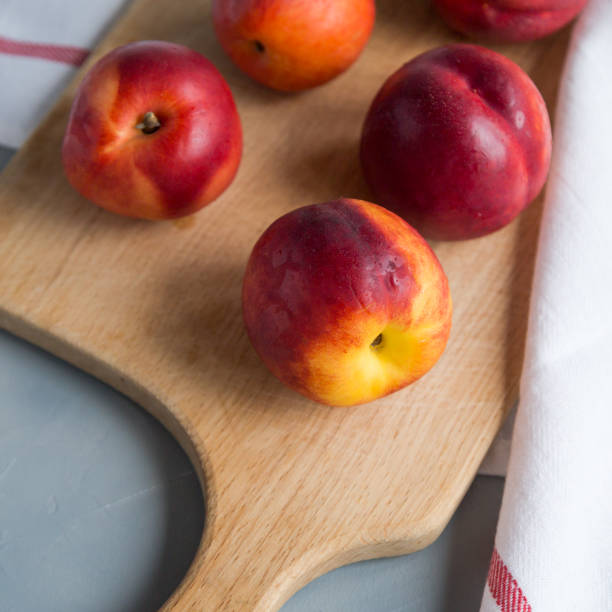 istock Fresh peaches on a plate, textile decoration 969860344