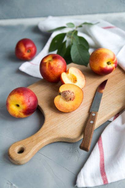 istock Fresh peaches on a plate, textile decoration 969860368