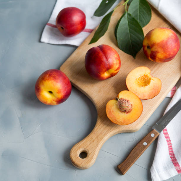 istock Fresh peaches on a plate, textile decoration 969860410