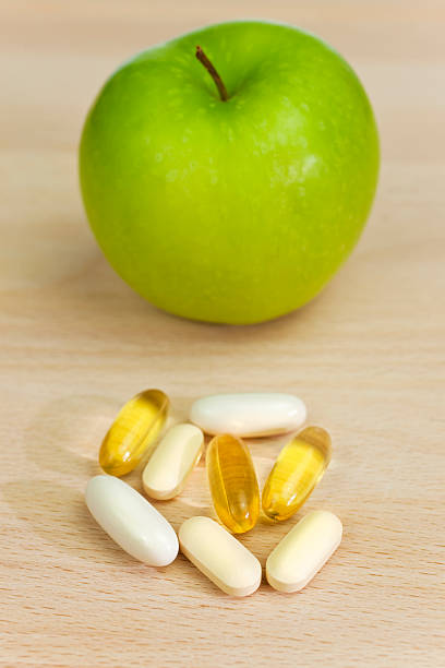 istock Green Apple and Nutrition Supplement Tablets or Medicine 96986083